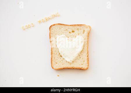 sandwich for breakfast in the form of heart with cheese - good morning inscription Stock Photo