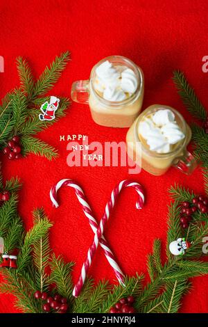 marshmellou cocoa and candy on a red background. The inscription Happy New Year. Stock Photo