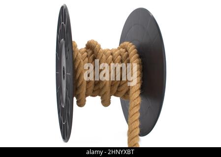 Braided natural jute rope wrapped on the reel isolated on white background Stock Photo
