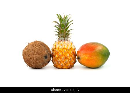 Whole coconut, pineapple fruit and multicolored mango isolated on a white background Stock Photo