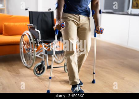 Man Using Crutches. Person After Accident With Leg Injury Stock Photo