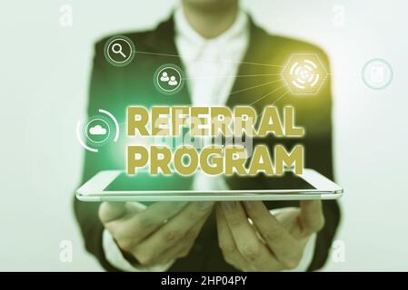Text sign showing Referral Program, Word Written on internal recruitment method employed by organizations Lady In Uniform Holding Touchpad Showing Fut Stock Photo