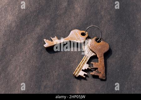 Bunch of old House Key isolated on a rustic Floor. High Angle View. Copy space room for text. Safety secure protection background concept. Stock Photo
