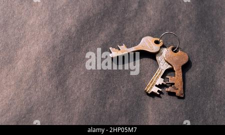 Bunch of old House Key isolated on a rustic Floor. High Angle View. Copy space room for text. Safety secure protection background concept. Stock Photo