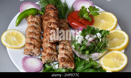 Lula kebab in Mediterranean cuisine with fresh herbs Stock Photo