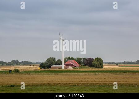 Wind wheels for renewble energy on the flat marshland of North Germany Stock Photo