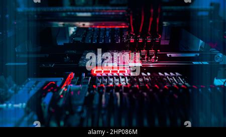 Automatic production of Computer Chips by SMT Pick and Place machine. Technological automaton for the production of electronic chips and motherboards. Chip Production and SMT manufacturing. Stock Photo