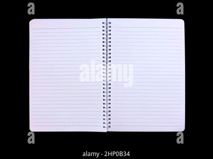 An open notebook: a white paper material, isolated over a black surface, thin blue lines on the sheets; a useful blank backdrop. Stock Photo