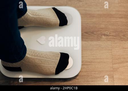 Modern Electronic Device. Girl Measures Weight on Smart Scales. Stock Photo