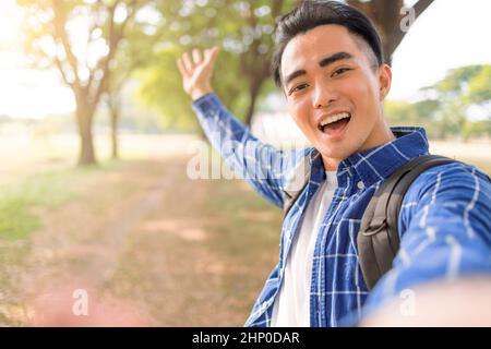 Happy handsome man takes a selfie portrait at vacation outdoor Stock Photo