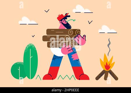 Smiling lumberjack or woodcutter hold wood pile set fire outdoors. Happy lumberman with wooden timber stack materials for camp in nature. Hobby and en Stock Photo