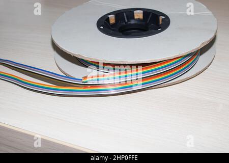Coil of multi-colored wires in hand close up Stock Photo