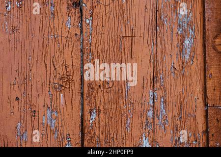 Texture of wooden boards with very worn brown paint. Wood background with chipped paint. Stock Photo