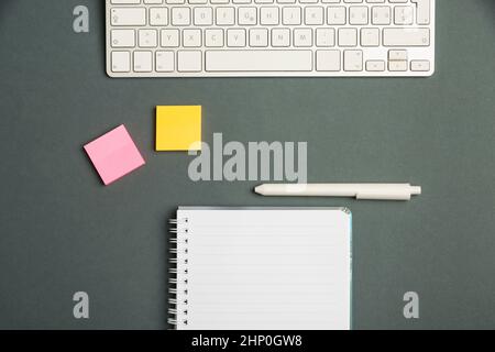 Keyboard Over A Table Beside A Notebook And Pens With Sticky Notes Stock Photo