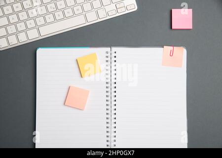 Keyboard Over A Table Beside A Notebook And Pens With Sticky Notes Stock Photo