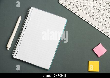 Keyboard Over A Table Beside A Notebook And Pens With Sticky Notes Stock Photo