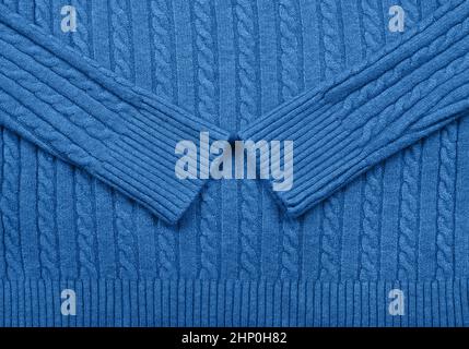 Close up background texture of blue cable knitted wool jersey fabric sweater with row braid pattern Stock Photo