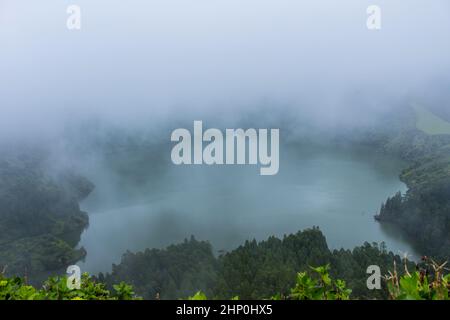Deep lake in Flores Island, Azores Archipelago, Portugal. Green lagoon with green vegetation Stock Photo