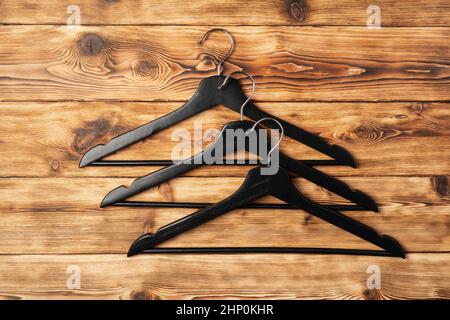 Composition with clothes hangers on wooden background. Stock Photo