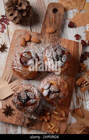 Baked apples with nuts and raisins. Homemade baked apples in the oven, with sugar powder close-up. Holiday dessert Stock Photo