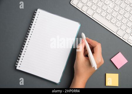 Keyboard Over A Table Beside A Notebook And Pens With Sticky Notes Stock Photo