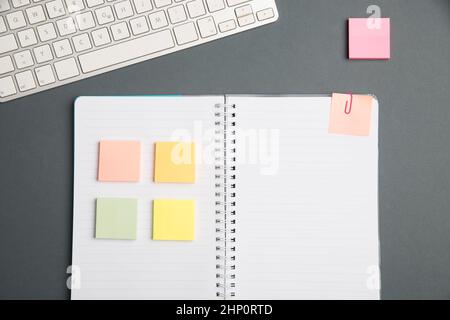 Keyboard Over A Table Beside A Notebook And Pens With Sticky Notes Stock Photo