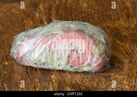 wrapped raw beef fillet on wood Stock Photo