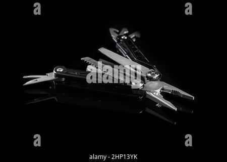 Multi-tools pliers with other tools and knife. Multifunction pliers. Stock Photo
