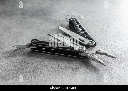 Multi-tools pliers with other tools and knife. Multifunction pliers. Stock Photo
