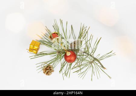 Christmas flat lay styled scene - top view frame with evergreen tree twigs and christmas decorations. Christmas composition of a fir branch and red to Stock Photo