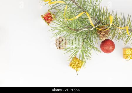 Christmas flat lay styled scene - top view frame with evergreen tree twigs and christmas decorations. Christmas composition of a fir branch and red to Stock Photo