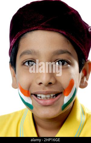 ndia Asia May. 21 2008 - Indian eight years old parsi boy with Indian Tricolour flag painted on face celebrating Independence day / Republic Day. Stock Photo