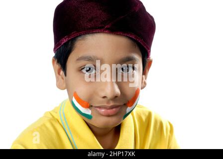 ndia Asia May. 21 2008 - Indian eight years old parsi boy with Indian Tricolour flag painted on face celebrating Independence day / Republic Day. Stock Photo