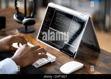 African American Coder Using Computer At Desk. Web Developer Stock Photo