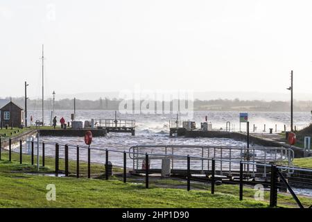 0900 Friday 18th February 2022. Storm Eunice: Lydney Harbour, Forest of Dean, River Severn, Gloucestershire. High tide and storm surge threaten to ove Stock Photo