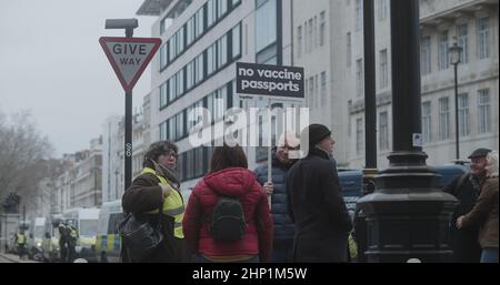 London, UK - 01 22 2022:  A male protester holding a sign, ‘No Vaccine Passports’, at Portland Place, for the ‘World Wide Rally For Freedom’. Stock Photo