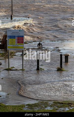 0900 Friday 18th February 2022. Storm Eunice: Lydney Harbour, Forest of Dean, River Severn, Gloucestershire. High tide and storm surge threaten to ove Stock Photo