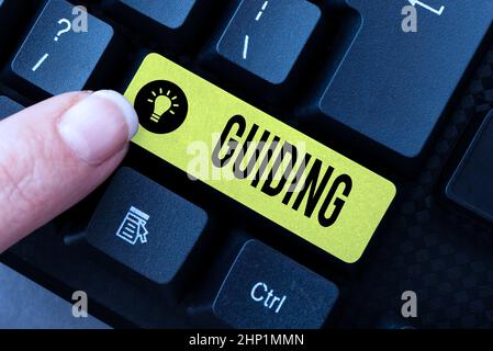 Hand writing sign Guiding, Conceptual photo to show someone how to do something difficult Indicate the way Transcribing Internet Meeting Audio Record, Stock Photo