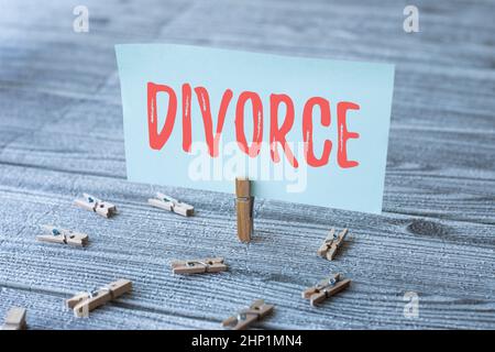 Conceptual caption Divorce, Business approach Legal dissolution of marriage Separation Breakup Disagreement Piece Of Blank Square Note Surrounded By L Stock Photo