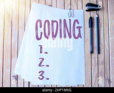 Writing displaying text Coding, Business showcase assigning code to something for classification identification Office Stationery Paper Clipped Togeth Stock Photo