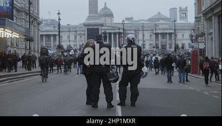 London, UK - 01 22 2022:  Two police officers talking to a female protester on Whitehall road. Stock Photo