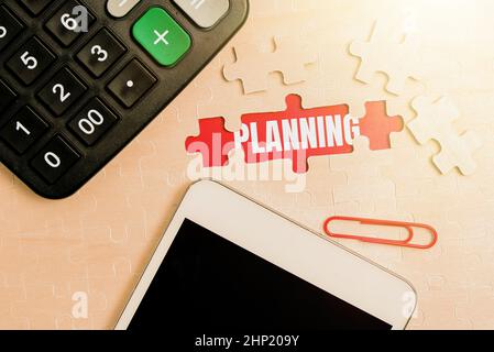 Conceptual caption Planning, Business concept process of thinking about the activities required to achieve a goal Building An Unfinished White Jigsaw Stock Photo
