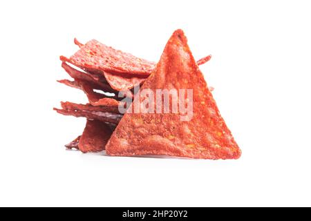 Salted tortilla chips triangle with red beet flavor isolated on white background. Stock Photo