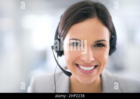She goes the extra mile for her clients. Shot of an attractive customer support agent. Stock Photo
