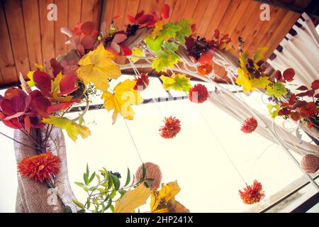 Autumn wedding decor arches in rustic style for the wedding ceremony on the river bank. Stock Photo