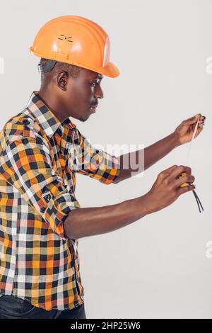 African American worker builder uses a measuring tape Stock Photo