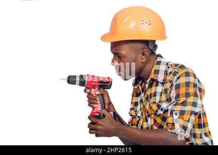 African American construction worker in helmet uses electric screwdriver Stock Photo