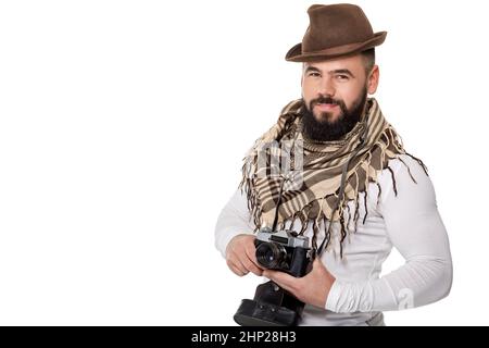 young male photographer with retro camera takes photos on white background Stock Photo