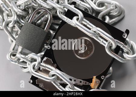 The hard drive is wrapped with a chain with a padlock Stock Photo