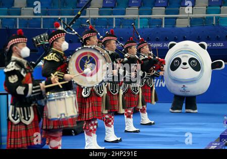 Olympic mascot Bing Dwen Dwen watches bagpipe players perform before the Women's Curling Semi-Final during day fourteen of the Beijing 2022 Winter Olympic Games at the National Aquatics Centre in Beijing, China. Picture date: Friday February 18, 2022. Stock Photo